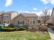 Inviting home exterior with well-maintained lawn and landscaping, complemented by stone accents and neutral siding at 10105 Grove Loop # D, Westminster, CO 80031