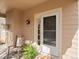 Inviting front porch with rocking chair, plants, and a welcoming entrance at 10105 Grove Loop # D, Westminster, CO 80031