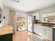 Bright kitchen with white cabinets, access to patio, and modern appliances at 10105 Grove Loop # D, Westminster, CO 80031
