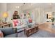 Bright living room with soaring ceilings, hardwood floors, and a view of the stairs at 10105 Grove Loop # D, Westminster, CO 80031