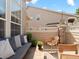Relaxing patio featuring comfortable seating, a wooden table, and a view of the surrounding neighborhood at 10105 Grove Loop # D, Westminster, CO 80031