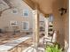 Welcoming covered porch with decorative columns, a rocking chair, and well-kept landscaping at 10105 Grove Loop # D, Westminster, CO 80031
