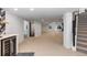 Spacious finished basement with neutral carpet, bar, and stairs leading up to the main level at 9561 Silver Hill Cir, Lone Tree, CO 80124
