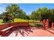 Red wood deck offering an inviting outdoor seating area amidst a beautifully landscaped backyard at 9561 Silver Hill Cir, Lone Tree, CO 80124