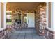Welcoming brick-paved front porch with large windows allowing natural light at 9561 Silver Hill Cir, Lone Tree, CO 80124