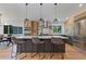Modern kitchen with stainless steel appliances, an island with barstool seating and lovely pendant lighting at 9561 Silver Hill Cir, Lone Tree, CO 80124