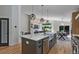 This kitchen has a large island, stainless steel appliances, and is open to the living room at 9561 Silver Hill Cir, Lone Tree, CO 80124