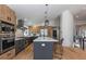 The kitchen is complete with stainless steel appliances, an island, and wood cabinetry at 9561 Silver Hill Cir, Lone Tree, CO 80124
