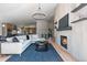 Spacious living room with a fireplace, TV, and hardwood floors, leading to the kitchen at 9561 Silver Hill Cir, Lone Tree, CO 80124