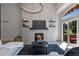 Bright living room with fireplace, shelves, natural light from sliding glass doors and comfortable seating area at 9561 Silver Hill Cir, Lone Tree, CO 80124