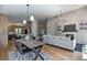 Open-concept living room boasts a cozy fireplace and adjacent dining area with stylish decor at 9561 Silver Hill Cir, Lone Tree, CO 80124