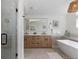 This modern main bath boasts double sinks, a soaking tub, and a glass shower at 9561 Silver Hill Cir, Lone Tree, CO 80124