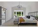 This airy main bedroom has a black chandelier and a view of the exterior at 9561 Silver Hill Cir, Lone Tree, CO 80124