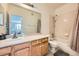 Well-lit bathroom with a shower-tub combo, white vanity, and a large mirror at 16828 E Gunnison Dr # 7H, Aurora, CO 80017