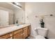 Clean bathroom featuring a single sink vanity with wood cabinets and a shower over tub at 16828 E Gunnison Dr # 7H, Aurora, CO 80017