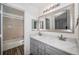 Bathroom with double vanity, quartz countertop, and bathtub at 1330 S Monaco Pkwy # 3, Denver, CO 80224