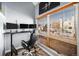 Home office with standing desk, two monitors, and large window at 1330 S Monaco Pkwy # 3, Denver, CO 80224