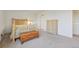 Bright bedroom featuring neutral decor, a comfortable bed, and matching wooden furniture with ample closet space at 14001 E Marina Dr # 607, Aurora, CO 80014