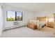 Cozy bedroom with natural light, showcasing a comfortable bed, chest, and scenic outdoor views through the window at 14001 E Marina Dr # 607, Aurora, CO 80014