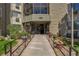 Inviting building entrance with landscaped walkway and manicured flowerbeds at 14001 E Marina Dr # 607, Aurora, CO 80014