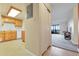 Kitchen that is brightly lit with wood cabinets and white counter tops flowing into the living room at 14001 E Marina Dr # 607, Aurora, CO 80014