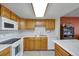 A bright kitchen with wood cabinets, white countertops, and appliances at 14001 E Marina Dr # 607, Aurora, CO 80014
