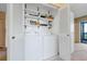 Convenient in-unit laundry area with white washer, dryer and shelving at 14001 E Marina Dr # 607, Aurora, CO 80014