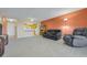Open concept living room featuring wood accents, comfortable seating, and a partial view of the kitchen at 14001 E Marina Dr # 607, Aurora, CO 80014