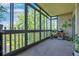 Bright sunroom with large windows and an abundance of natural light, showcasing serene outdoor views and plant display shelves at 14001 E Marina Dr # 607, Aurora, CO 80014