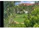 Scenic view of a lush green golf course from the property, framed by mature trees and landscaping at 14001 E Marina Dr # 607, Aurora, CO 80014