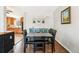 Bright dining area with kitchen view, hardwood floors, and a four-person table at 6090 Cody St, Arvada, CO 80004