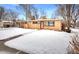 Ranch-style home with snow-covered yard at 6090 Cody St, Arvada, CO 80004