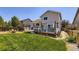 Backyard featuring a wooden deck, lush lawn, and exterior of the house at 11357 Iola St, Commerce City, CO 80640
