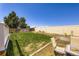 Grassy backyard with a partial fence, landscaping project, and outdoor seating at 11357 Iola St, Commerce City, CO 80640