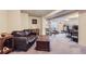 Finished basement with cozy leather furniture, dining area, and workout space at 11357 Iola St, Commerce City, CO 80640