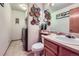 Well-lit powder room featuring modern fixtures, decor, and a washer/dryer at 11357 Iola St, Commerce City, CO 80640