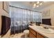 Cozy bathroom with a charming forest-themed shower curtain and framed artwork at 11357 Iola St, Commerce City, CO 80640