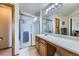 Functional bathroom with a shower, large mirror, and vanity at 11357 Iola St, Commerce City, CO 80640