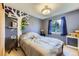 Unique bedroom with a tree decal wall, window, and carpeted floor at 11357 Iola St, Commerce City, CO 80640