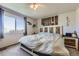 Cozy bedroom with a decorative headboard and a large window with natural light at 11357 Iola St, Commerce City, CO 80640