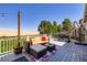 Outdoor deck with comfortable seating, barbecue grill, and scenic backyard view at 11357 Iola St, Commerce City, CO 80640