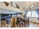 Open-concept dining and living space, featuring a game room and cozy living area at 11357 Iola St, Commerce City, CO 80640