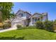 Inviting home showcasing a well-kept lawn, a covered front porch, and classic architectural details at 11357 Iola St, Commerce City, CO 80640