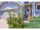 Close-up showcasing the welcoming front porch with colorful flowers and decorative elements at 11357 Iola St, Commerce City, CO 80640