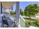 Cozy front porch featuring comfortable seating and views of the landscaped front yard and street at 11357 Iola St, Commerce City, CO 80640