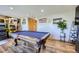 Spacious game room with a pool table and patriotic decor; great for entertaining at 11357 Iola St, Commerce City, CO 80640