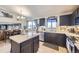 Charming kitchen with dark cabinetry, a center island, and stainless steel appliances at 11357 Iola St, Commerce City, CO 80640