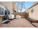 Wide view of the backyard features a privacy fence and sliding doors into the home at 2925 S Vaughn Way, Aurora, CO 80014