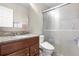 Bathroom featuring a glass shower door, granite vanity, and modern toilet at 2925 S Vaughn Way, Aurora, CO 80014