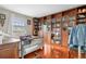Bedroom featuring hardwood floors, built-in bookcase, and natural light at 2925 S Vaughn Way, Aurora, CO 80014